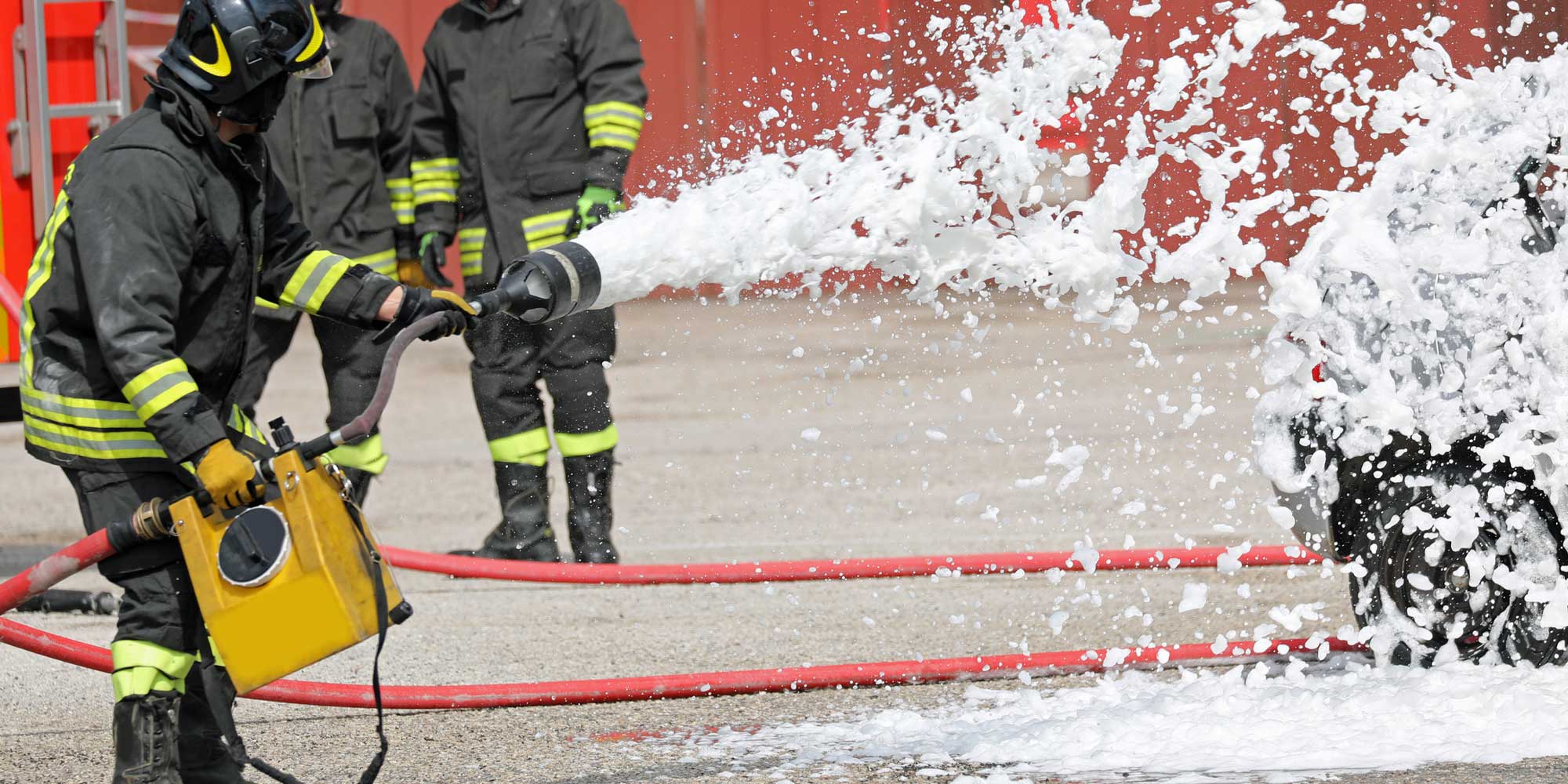 Firefighter extinguishing car with foam